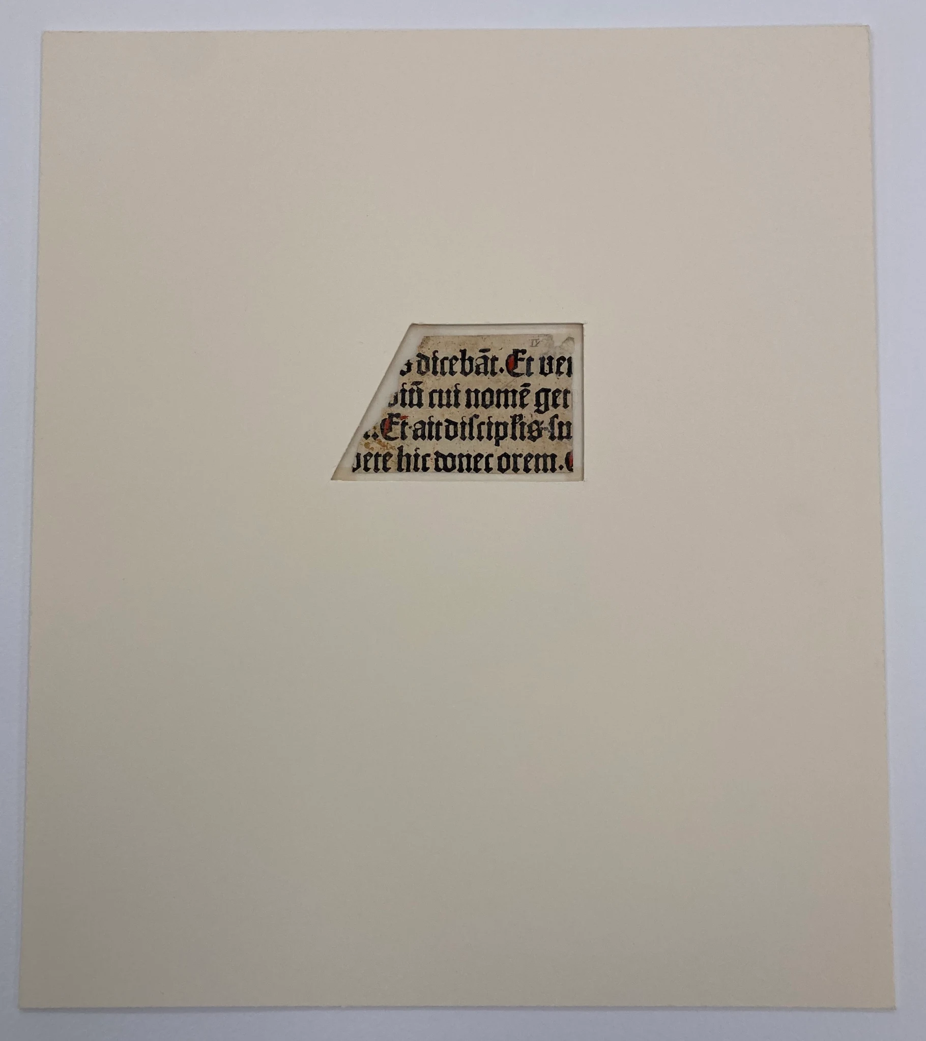 A photography by Erik Kwakkel of a manuscript fragment bound in the center of a large canvas. It shows where the rest of the manuscript likely was and how much of the sheet that’s been lost to time.